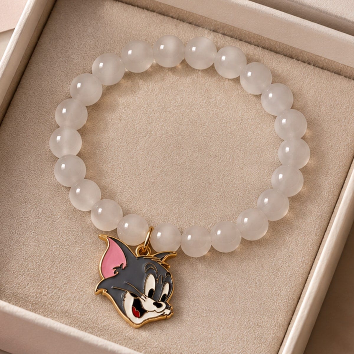 The moonstone cat charm bracelet resting in its gift box